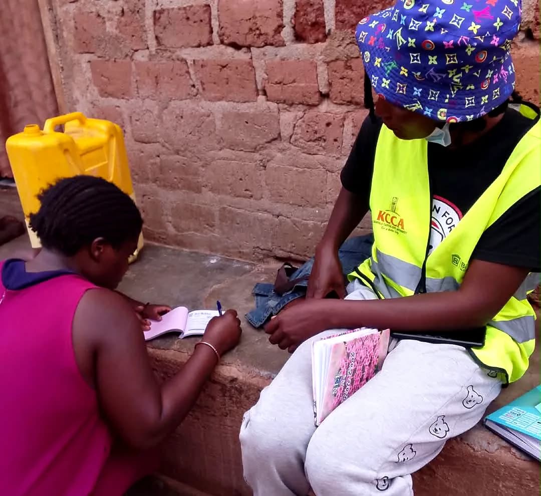 An officer in a high-visibility vest registering a customer at her door